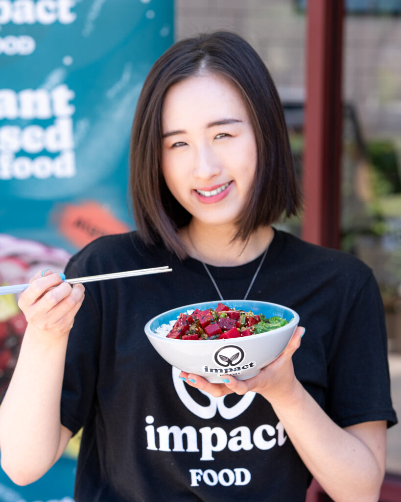 Co-Founder Kelly Pan smiles while enjoying a bowl of delicious Impact Tuna.