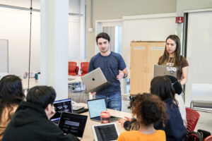 Course coordinators Rene Martinez Doehner and Aria Yang facilitating rotating mentorship with student product teams in Product Management course