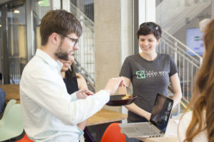 UC Berkeley students Joshua Nixon and Kimberlie Le serving their plant-based fish product to Christie Legally, senior scientist at the Good Food Institute