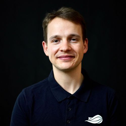 Co-founder Thomas Laporte smiles for a headshot with a dark background